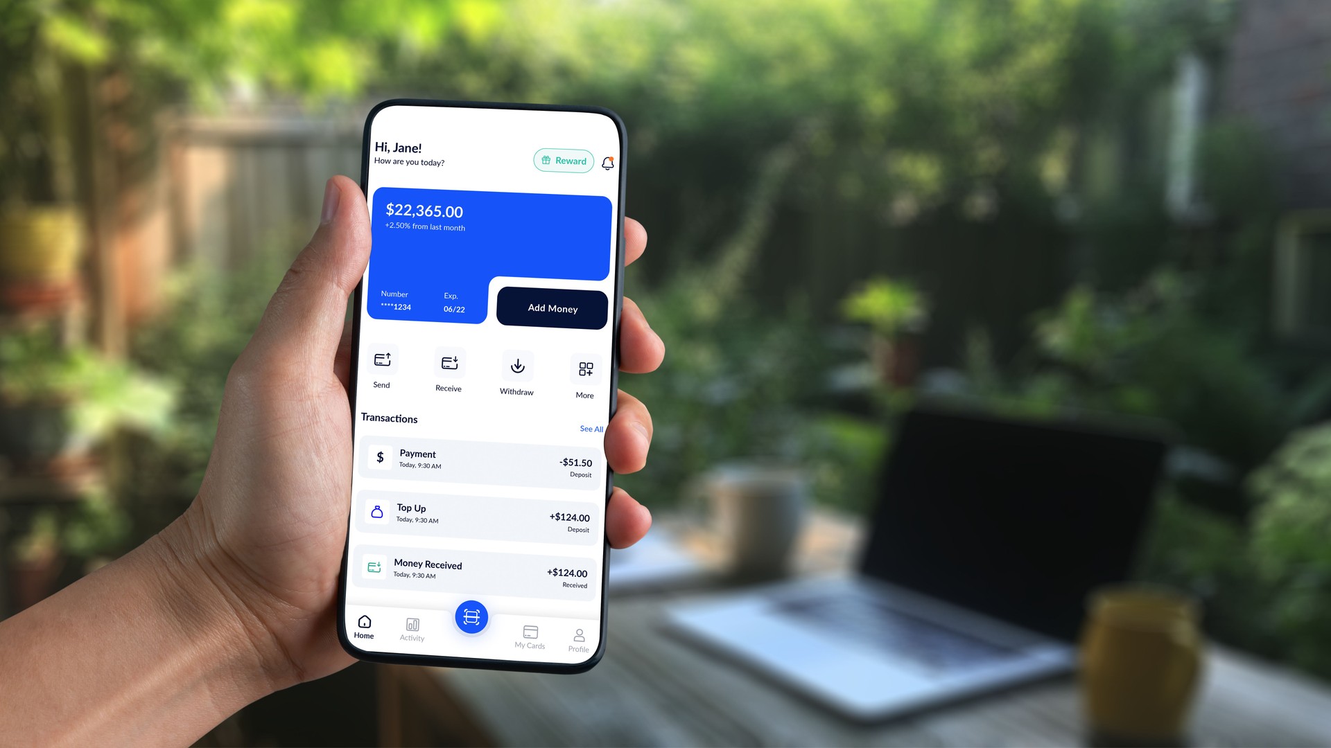 Hand Holding Smartphone Displaying Online Banking App Interface Outdoors with Laptop and Coffee Cup in Background, Concept of Modern Finance Management. Agnostic
