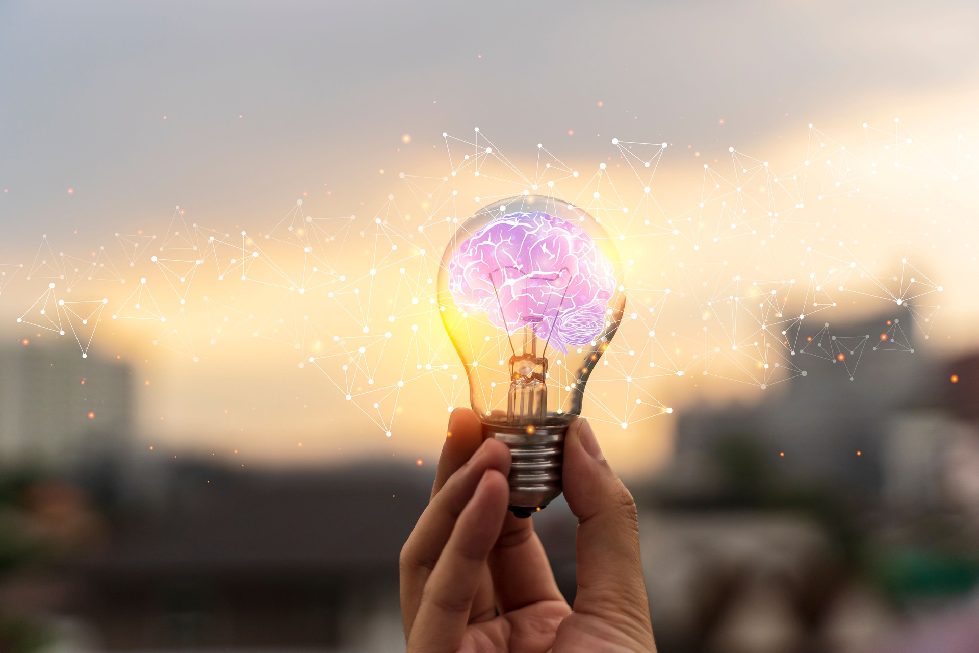 Businessman holding Light bulbs with Brain inside and Low poly wireframe outside. Creative and innovation inspiration.